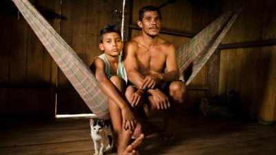 A man and boy sit on a hammock in CazumbÌÁ-Iracema Extractive Reserve in Acre, Brazil. The CazumbÌÁ-Iracema Extractive Reserve is part of the Amazon Region Protected Area program.